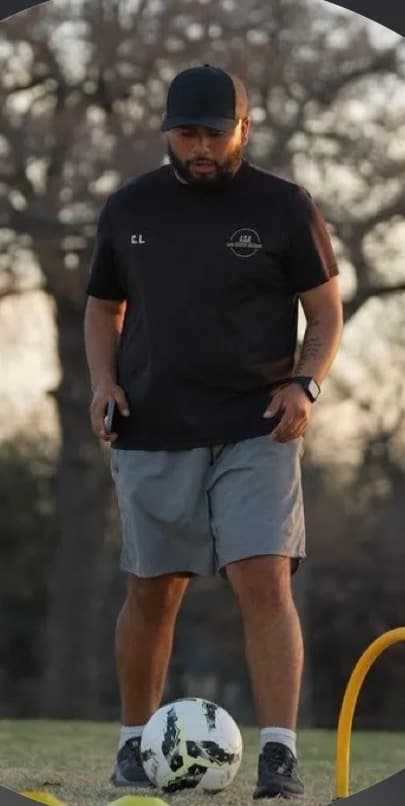 Coach Carlos Lara running a training session